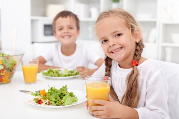 Kids eating a healthy meal in the kitchen