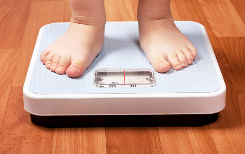 Closeup view of scales on a floor and kids feet; Shutterstock ID 75942880; PO: The Huffington Post; Job: The Huffington Post; Client: The Huffington Post; Other: The Huffington Post