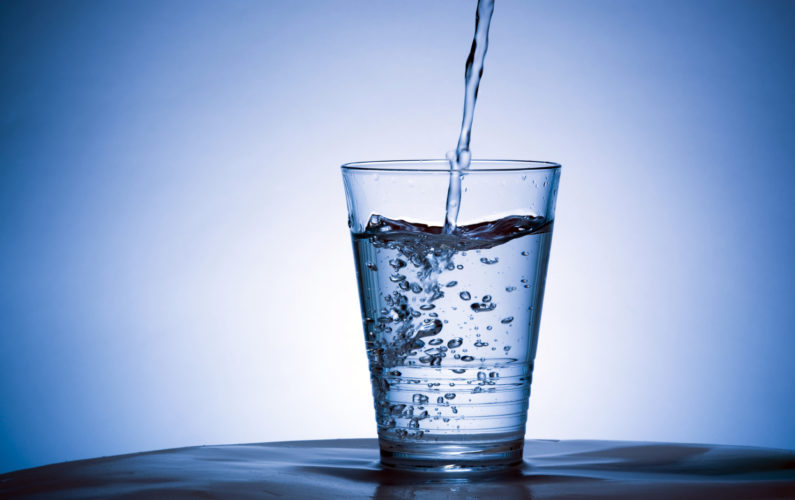 Cold water being poured into a glass.